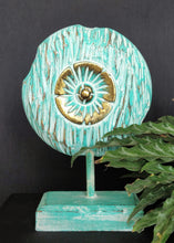 Table Decoration. Decorative hand carved wooden floral disc on stand.