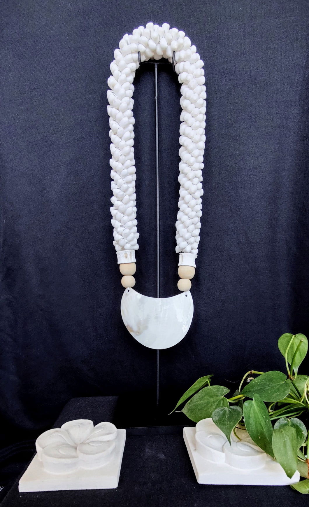 Home Decor. Mother Of Pearl Crescent Necklace with Shells and Wooden Beads on stand.