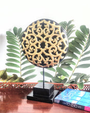 TABLE DECOR: Floral inspired beautiful Asian carved wooden disc mounted on a stand.