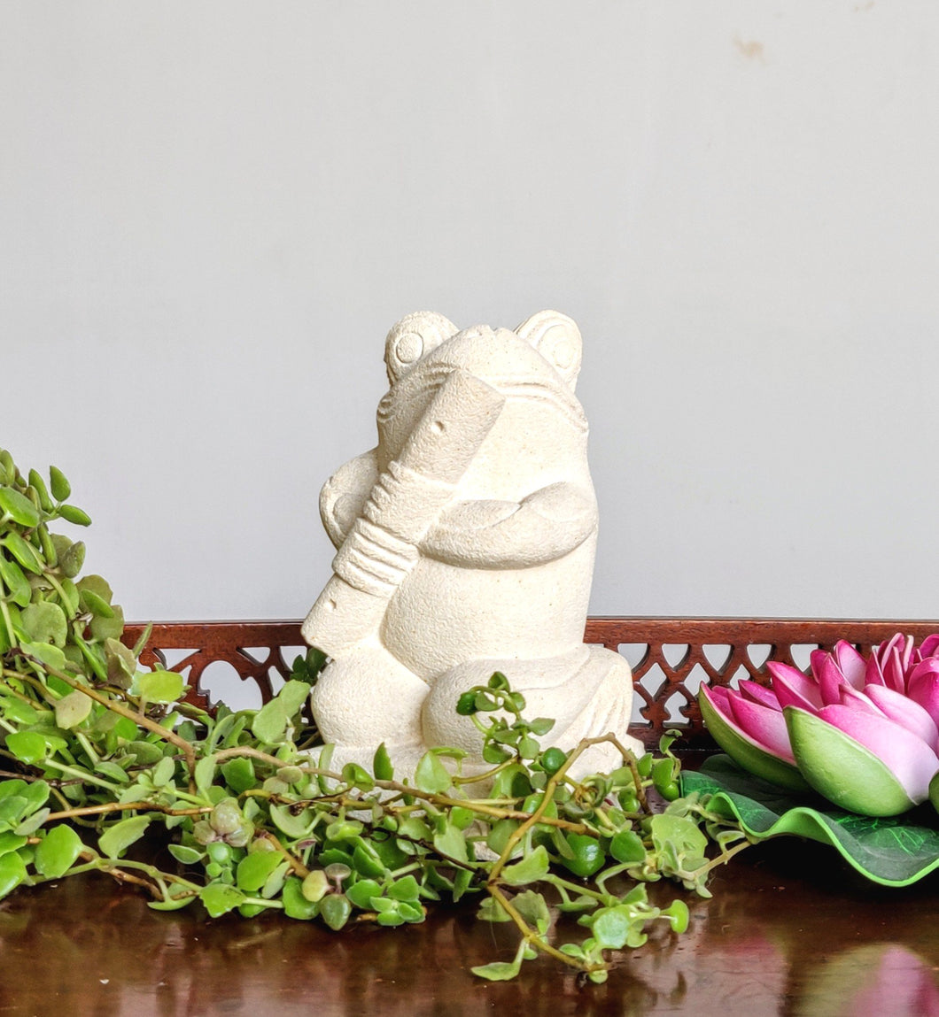 TABLETOP / GARDEN DECOR / FIGURINE: Handcrafted Cute Frog Sculpture in sandstone playing the flute.