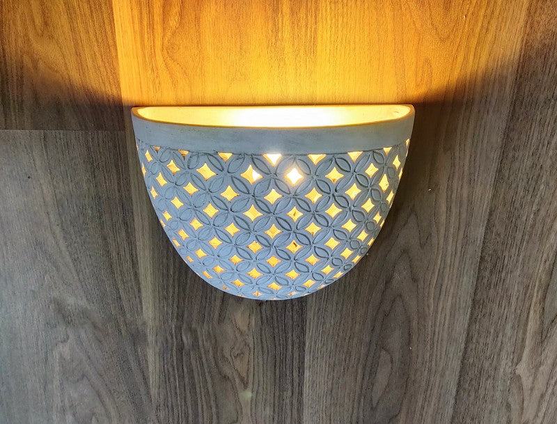 LIGHTING: Wall light fixture in Batik design. Imported.