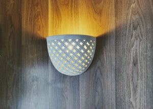 LIGHTING: Wall light fixture in Batik design. Imported.
