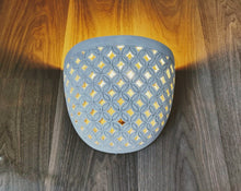 LIGHTING: Wall light fixture in Batik design. Imported.