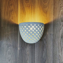 LIGHTING: Wall light fixture in Batik design. Imported.